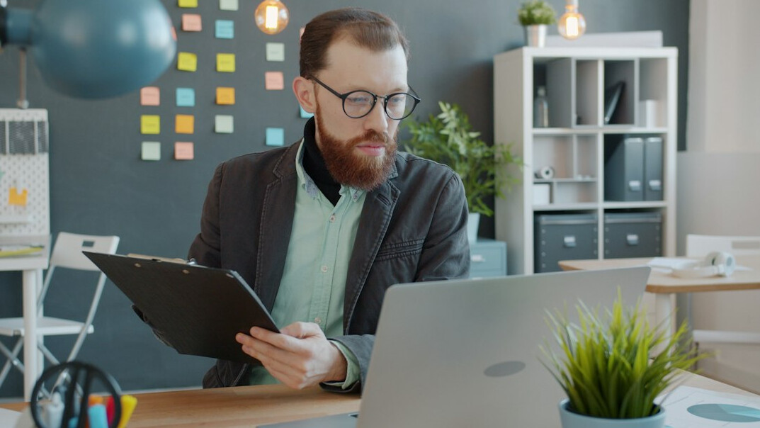 man negotiating contract at desk
